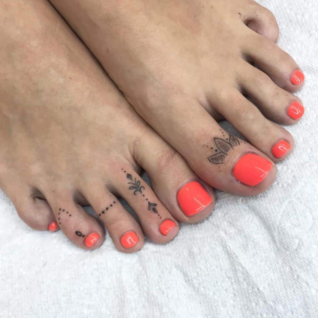 Idea femenina del tatuaje de los dedos de los pies