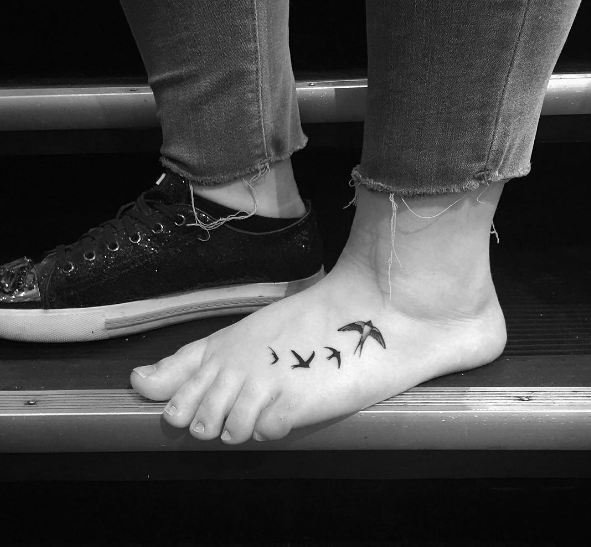 Finos tatuajes femeninos en el pie