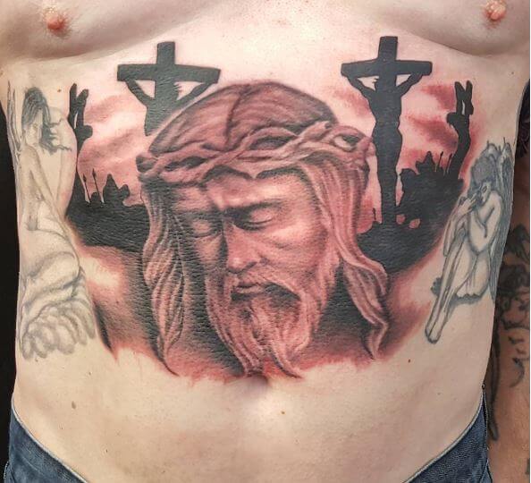 Diseño de tatuajes de Jesucristo en el estómago