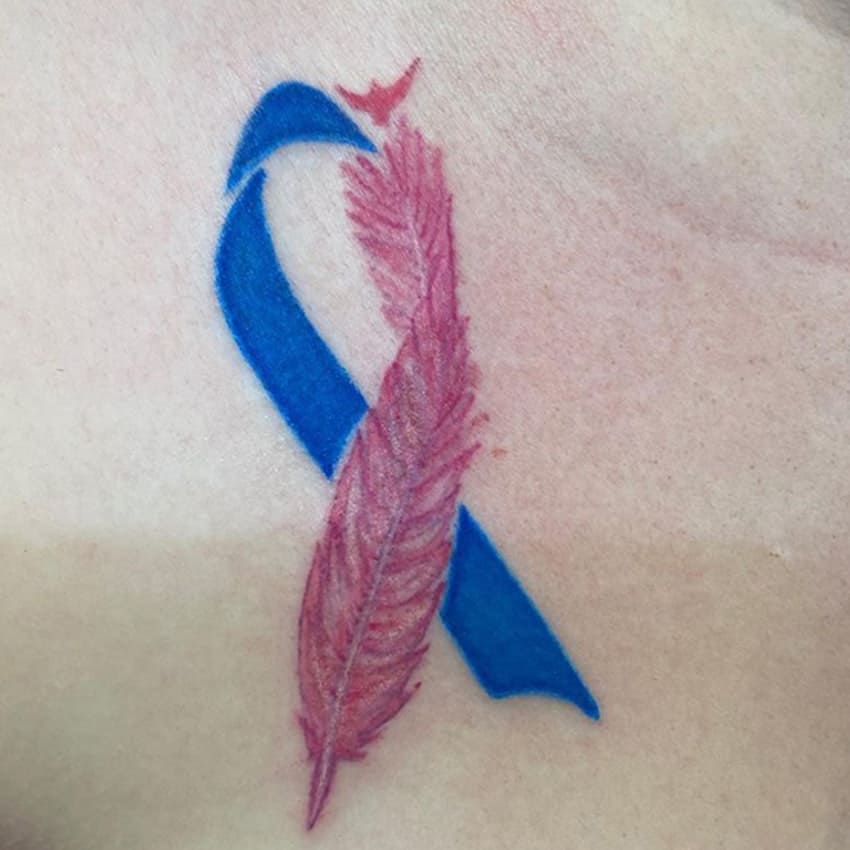 https://images.baThe Pink and Blue Ribbon Tattoouerhosting.com/motherandbaby/legacy/root//misaborto-tatuajes-ribbon-and-feather.jpg?q=80&w=850