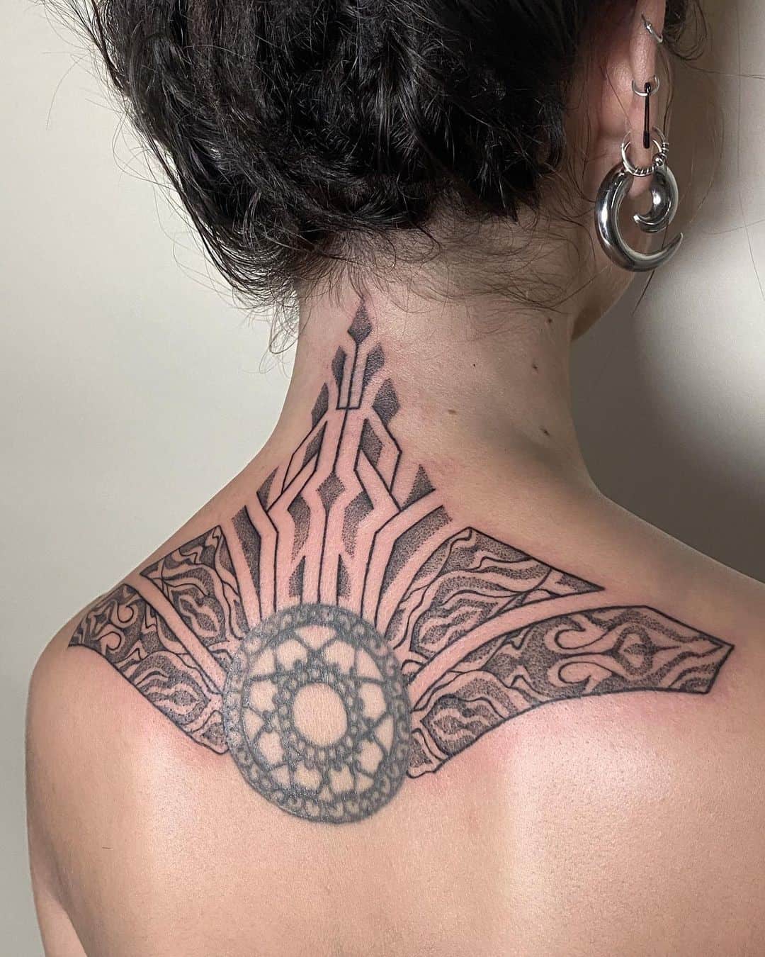 tatuaje de la flor de la vida en el cuello 