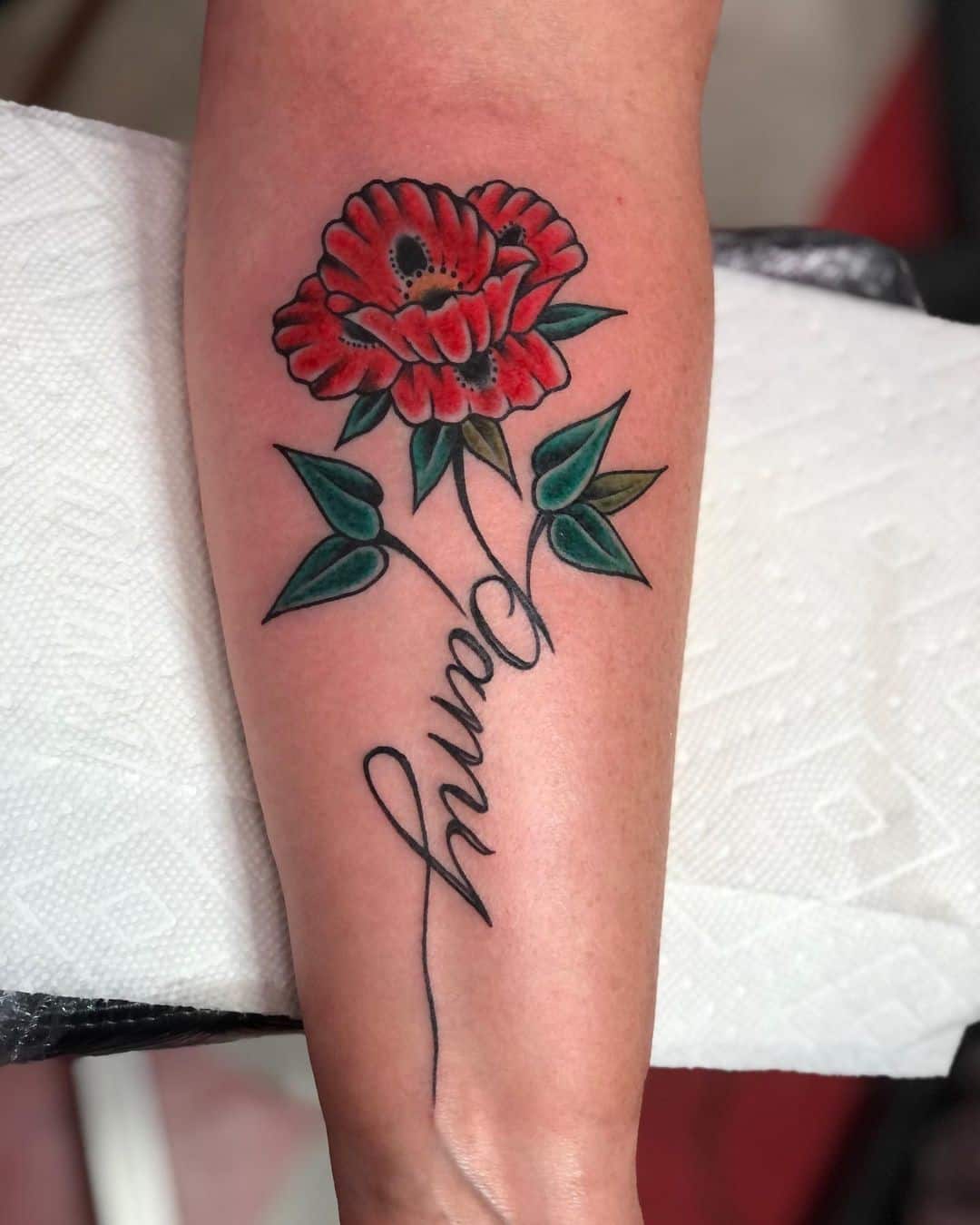 Tatuaje de flor de amapola roja con etiqueta de nombre