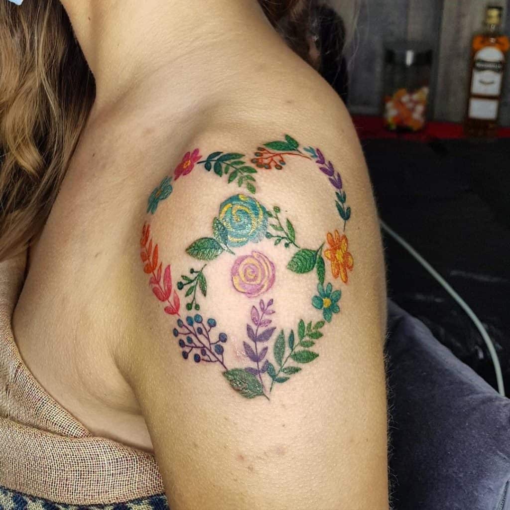 Tatuaje floral del símbolo de la paz en el hombro